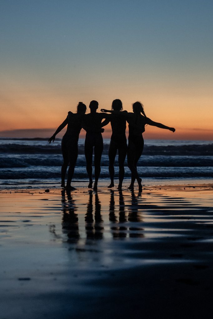 A group of girls at sunset on the beach